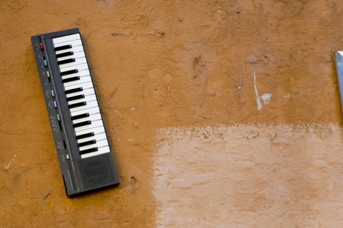 Small electronic keyboard mounted to wall