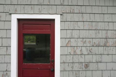 Red Door and Weathered Gray Wall