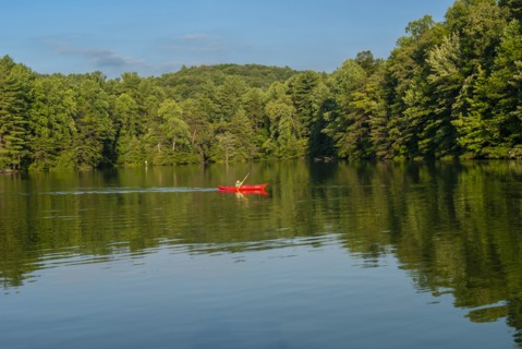 Boy in Red Kayak on Lake