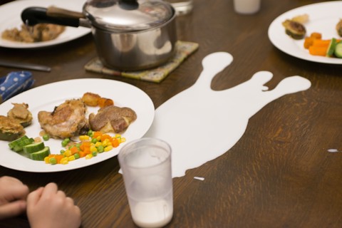 Cup of Spilled Milk on Dinner Table
