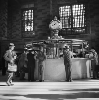 Group of People gathered around Information Booth