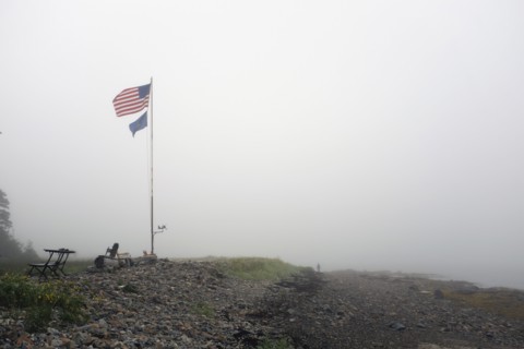 American Flag blowing in Wind on Foggy Beach