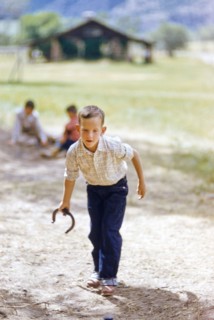 Young boy playing Horseshoes