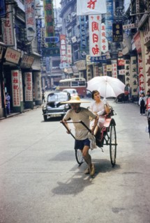 Man pulling Woman in Rickshaw