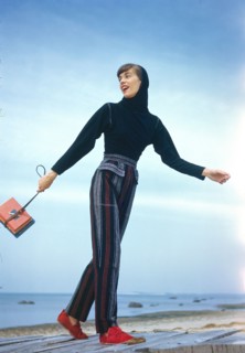 Fashionable Young Adult Woman in Striped Slacks and Hooded Top