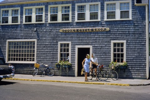Two Women with Bicycles in front of Cycle Shop