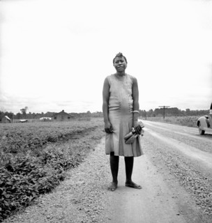 Full-Length Portrait of Woman carrying her Shoes Home  from Church