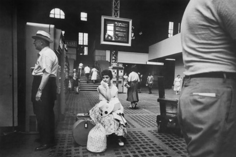 Woman sitting with Luggage