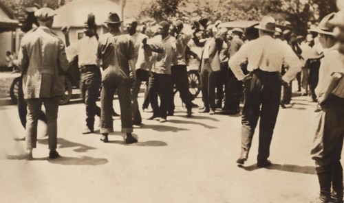 Detained African American men with Hands raised