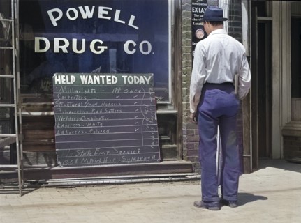 Man looking at Help Wanted Sign in Store Window