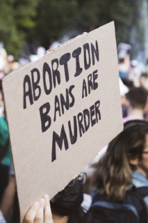 Abortion Bans are Murder Sign at Abortion Rights Rally