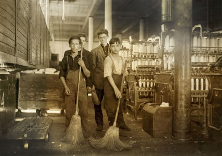 Young sweepers in spinning room of textile mill