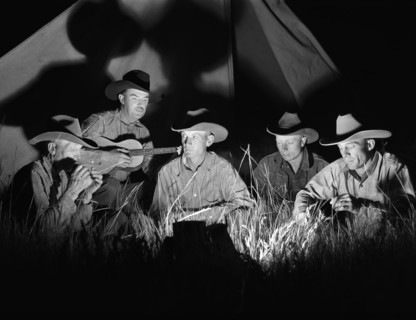 Cowhands singing after day's work