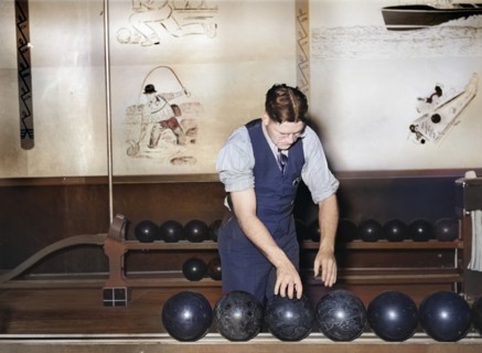 Man choosing bowling ball at bowling alley