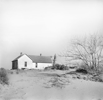 Shifting drifts of soil forcing farmer to abandon his home