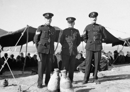 Three British constables as guests at tribal lunch at cavalry post 20 miles North of Beersheba