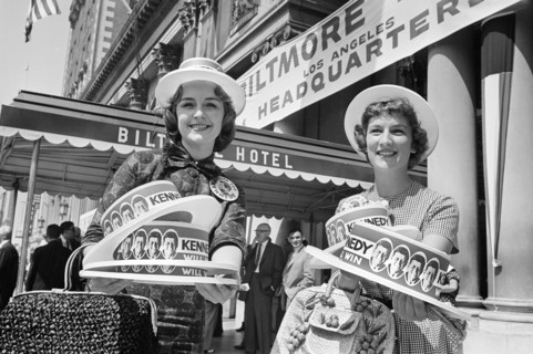 Two women selling hats supporting Senator John F. Kennedy outside Biltmore Hotel during Democratic National Convention