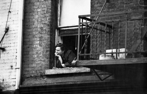 Woman leaning out building window