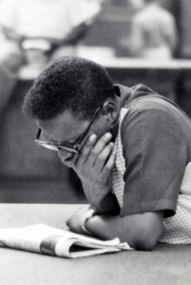 Half-length portrait of man reading newspaper