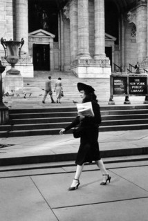 Woman walking in front of New York Public Library