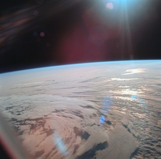 View of Earth showing clouds over water taken by Apollo 11 crewmembers from Apollo 11 spacecraft following translunar injection