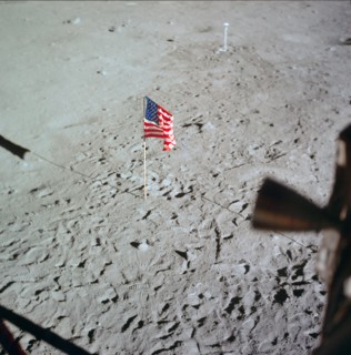 U.S. flag deployed on moon surface surrounded by footprints of astronauts Neil A. Armstrong and Edwin E. Aldrin Jr.