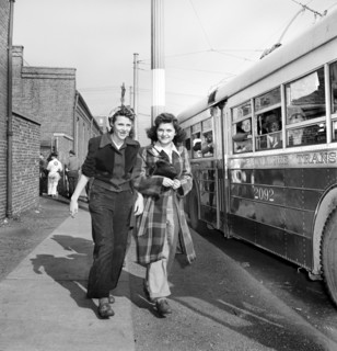 Two Young Women catching the trackless trolleys after work at 4pm, Baltimore, Maryland, USA,