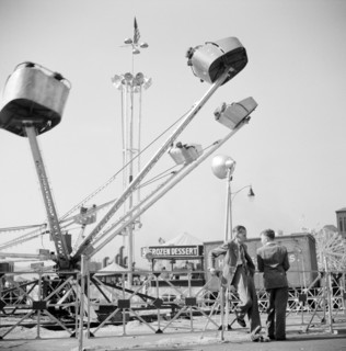 Two teen boys talking near carnival ride, Cotton Carnival, Memphis, Tennessee, USA, Marion Post