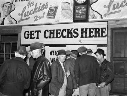 Farmers in warehouse getting their checks after tobacco auction sale, Durham, North Carolina, USA,