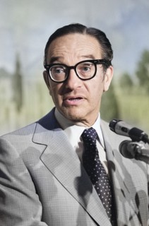 U.S. economist Alan Greenspan, head and shoulders portrait standing at microphones, Washington, D.C
