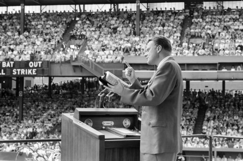 Evangelist Billy Graham preaching to crowd at crusade, Griffith Stadium, Washington, D.C., USA,