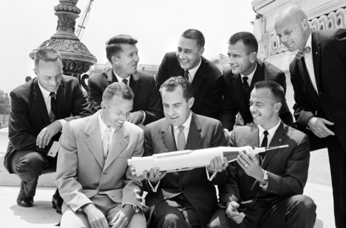 U.S. Vice President Richard Nixon holding model of rocket with Mercury Seven astronauts (left to