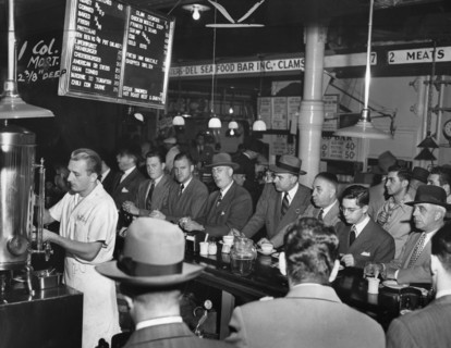 Group of men eating and drinking at Pete's Bar, Washington Market, New York City, New York, USA, Al