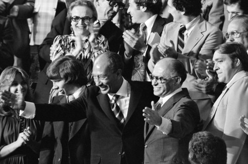 Egyptian President Anwar Sadat and Israeli Prime Minister Menachem Begin acknowledge applause