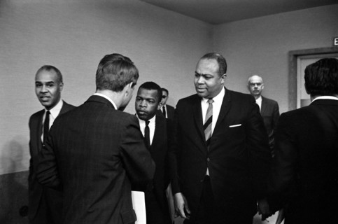 Roy Wilkins, John Lewis shaking hands with Robert F. Kennedy (with his back to the camera), and