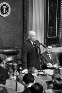 U.S. President Dwight Eisenhower speaking in front of microphones at press conference, Washington,
