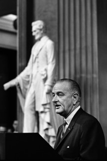 U.S. President Lyndon Johnson delivering remarks from behind podium during signing ceremony for the