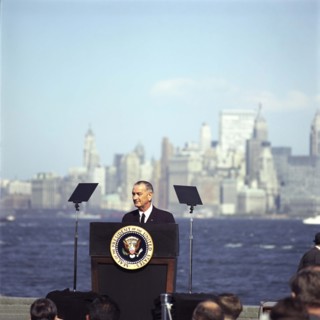 U.S. President Lyndon B. Johnson speaking at podium before signing the Immigration and Nationality
