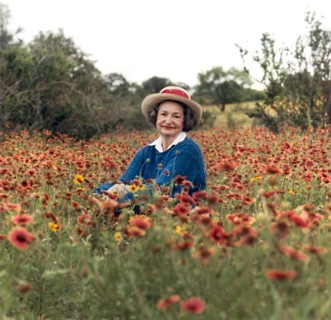 Former U.S. First Lady Lady Bird Johnson sitting in field of wildflowers, Texas, USA, Frank Wolfe,