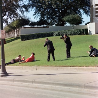 Witnesses laying down in grass immediately following assassination of U.S. President John Kennedy.