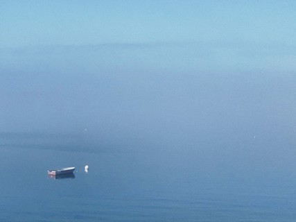 Moored rowboat at sea