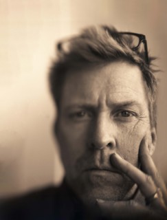 Head and shoulders portrait of contemplative mid-adult man