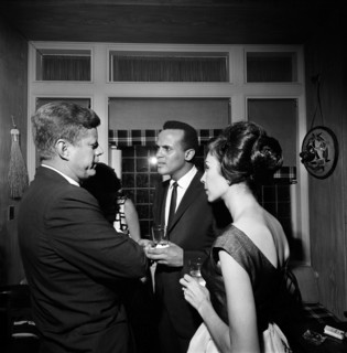 U.S. President John F. Kennedy talking with singer, Harry Belafonte, and Julie Robinson Belafonte