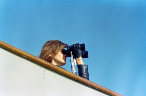 U.S. First Lady Jacqueline Kennedy watching through binoculars fourth  race of America's Cup from