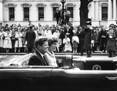 U.S. President John F. Kennedy and Eunice Kennedy Shriver travel in Presidential convertible