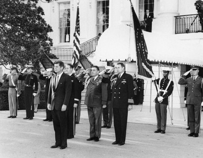 U.S. President John F. Kennedy (left, foreground) attending military reception in honor of