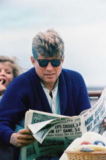 U.S. President John F. Kennedy reading newspaper with  his daughter, Caroline Kennedy in