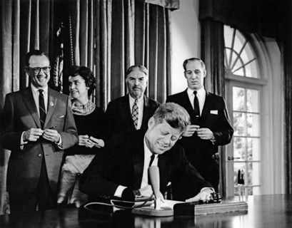 U.S. President John F. Kennedy signing joint resolution in support of Detroit's bid to host 1968