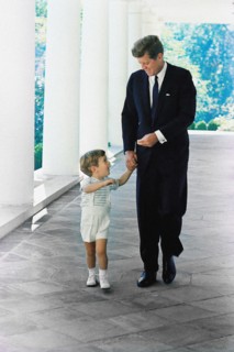 U.S. President John F. Kennedy walking with his son, John F. Kennedy, Jr., along West Wing