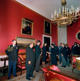 Jacqueline Kennedy, standing next to U.S. Senator Edward Kennedy, shaking hands with Minister of